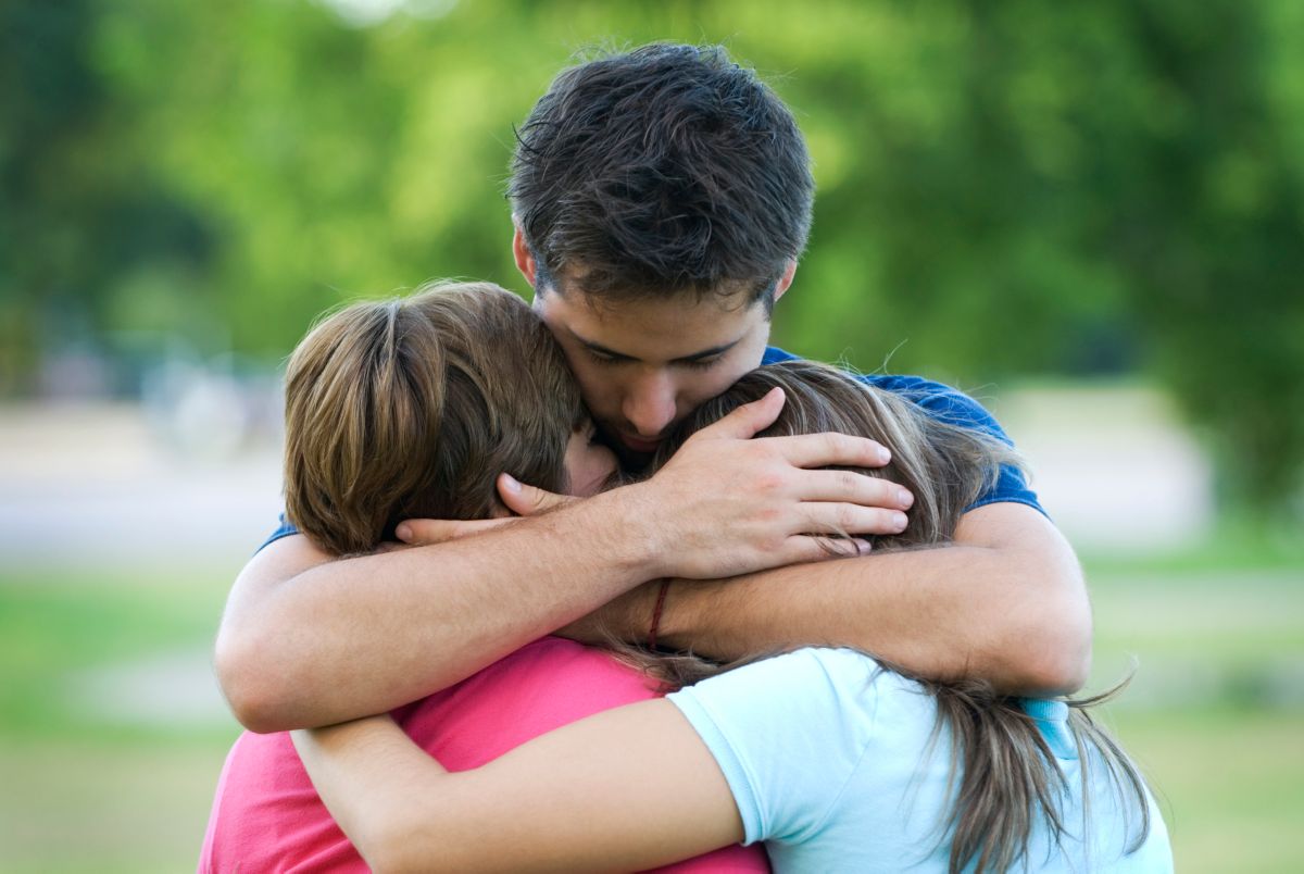 Group comforting grieving person