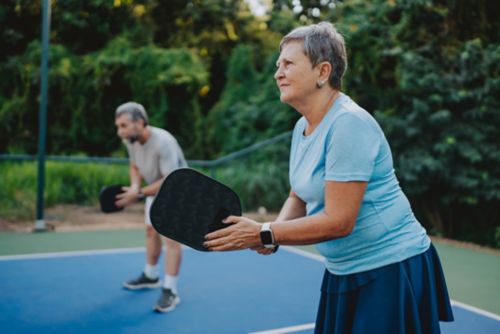Two retirees playing pickle ball
