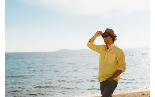 Man wearing long sleeved shirt on beach
