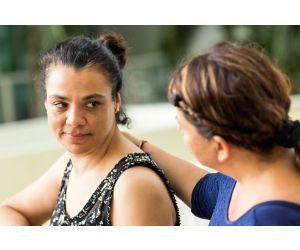 Woman comforting female friend