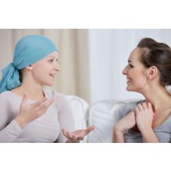 Young cancer woman wearing headscarf, talking with friend