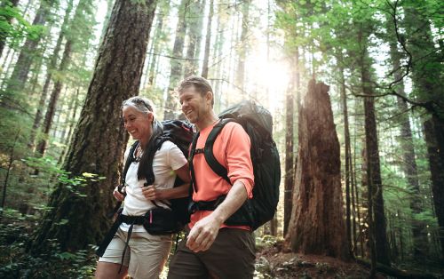 photo of couple hiking in the woods
