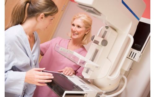 stock photo of woman talking to nurse before getting a mammogram