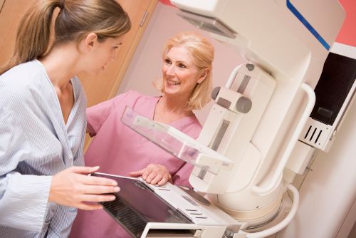 stock image of woman about to get mammogram talking to nurse