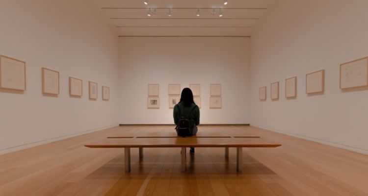 stock image of person sitting in art gallery