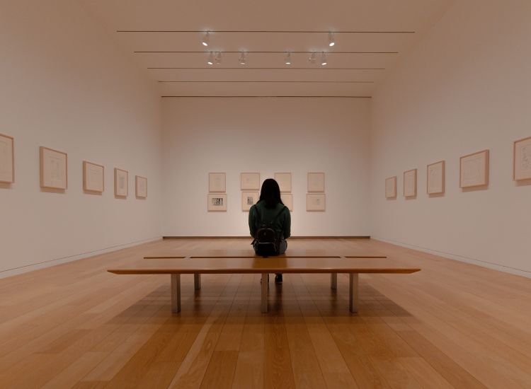 stock image of person sitting in art gallery
