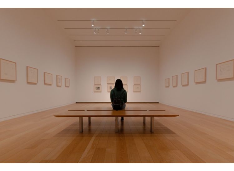 stock image of person sitting in art gallery