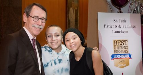 Photo of James Downing with two patients