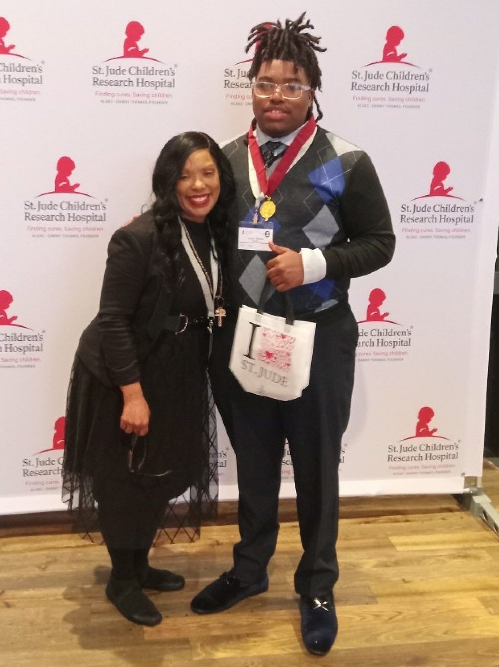 Jayden Dabney and his mother, Jacquelyn Johnson, celebrate his membership in the Society of High School Scholars at a ceremony at St. Jude.