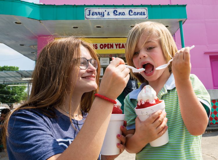 Photo of woman and child eating snocones