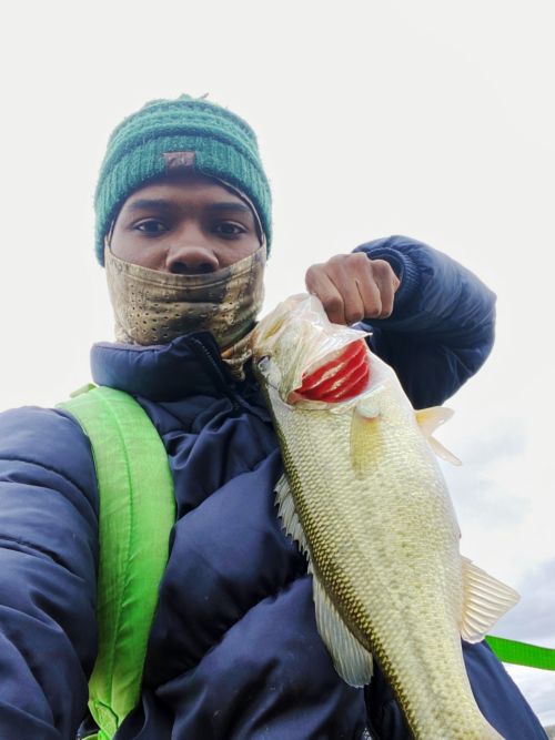 Jolly holding up a fish he caught