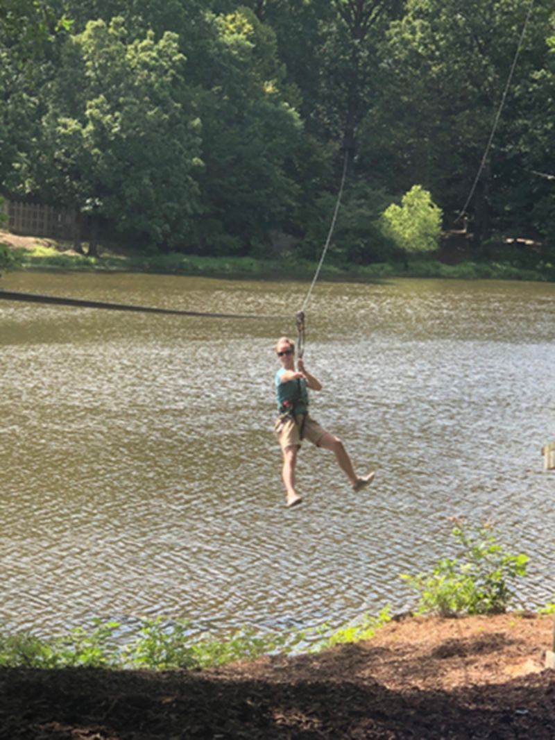 Kriwacki lab member does rope course over lake at Shelby Farms