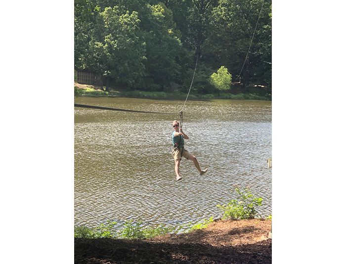 Kriwacki lab member does rope course over lake at Shelby Farms