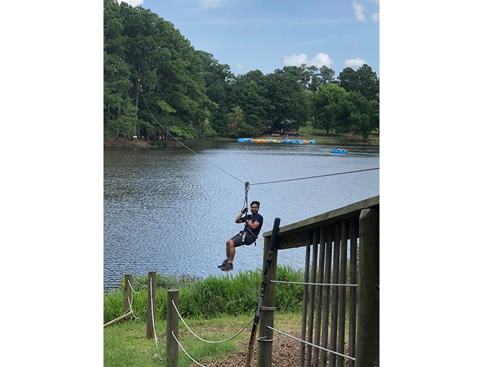Kriwacki lab member does rope course over lake at Shelby Farms