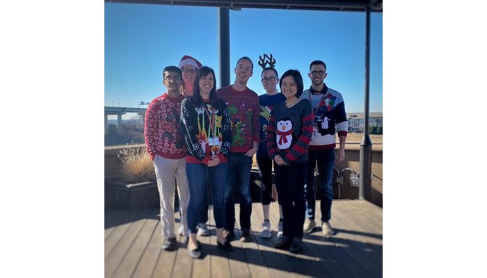 Kriwacki lab members wearing Christmas sweaters 