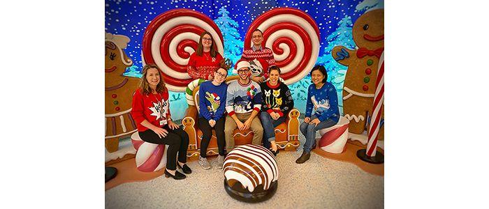 Kriwacki lab members wearing Christmas sweaters