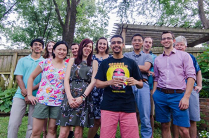 Group poses together outside at backyard lab party