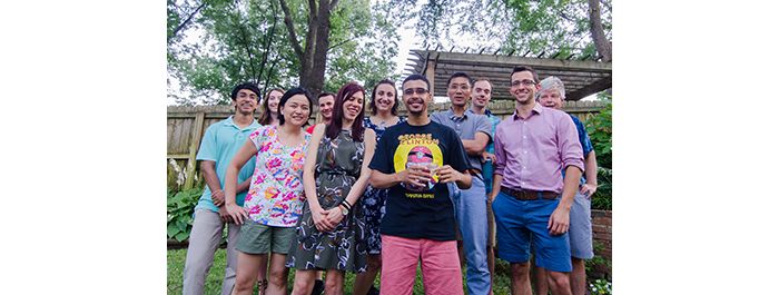 Group poses together outside at backyard lab party