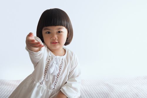 Little female child holding hand out