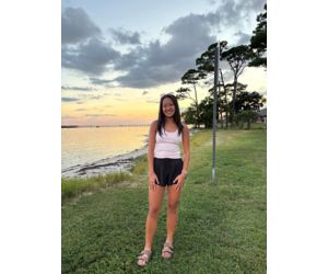 Lauren standing outdoors near water