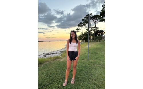 Lauren standing outdoors near water