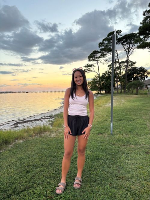 Lauren standing outdoors near water