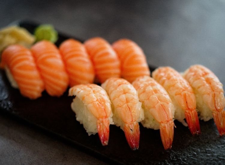 Close up of sashimi sushi with shrimp and salmon.