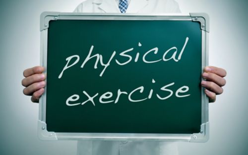 Doctor holding sign that says "physical exercise"