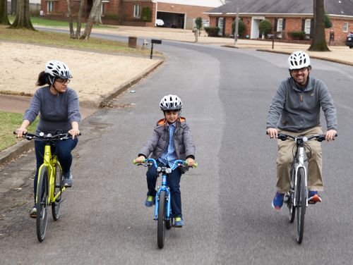 Photo of man, woman and child on bicycles