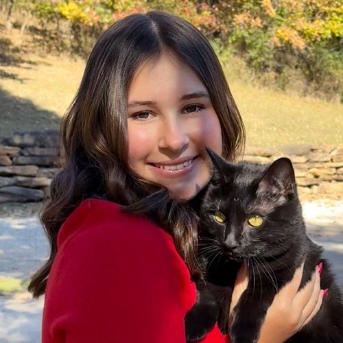 Madi holding black cat