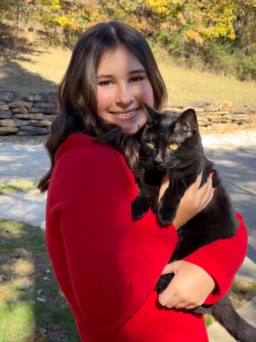 Madi holding black cat