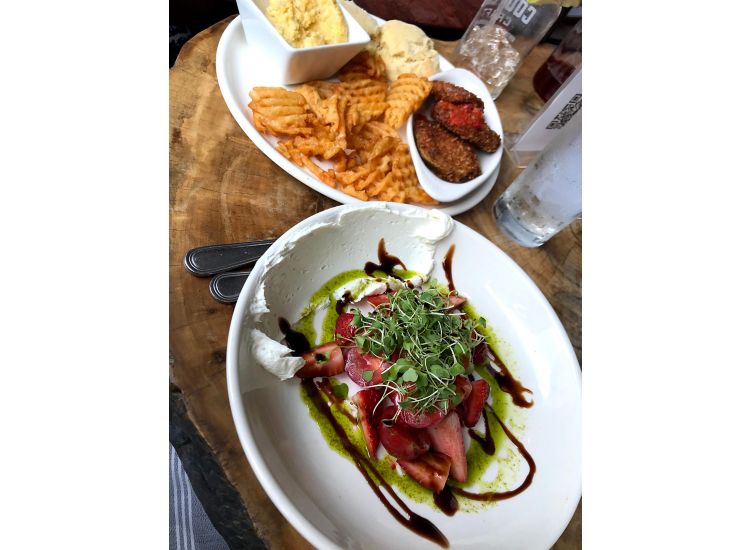 Two plated dishes at Magnolia and May Restaurant in Memphis.