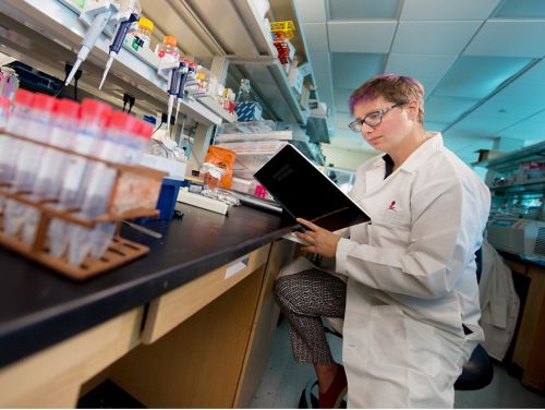 Photo of Ellie Margolis at lab bench