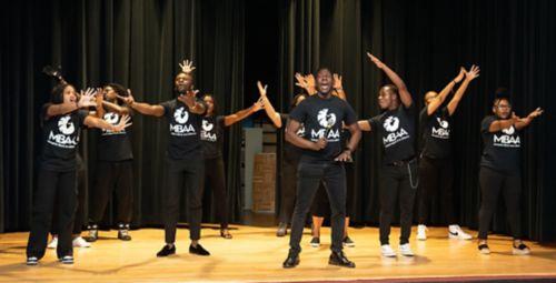 group of actors/dancers on a stage