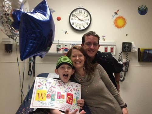 Micah pictures with his parents after finishing chemotherapy