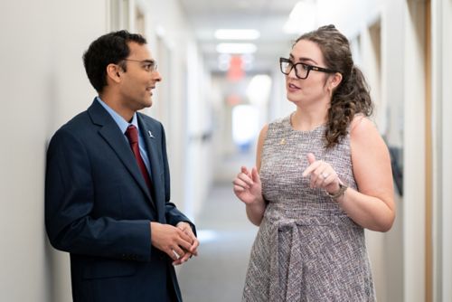 man and woman talking in the hall