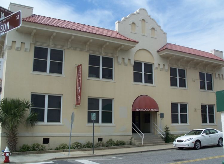 Exterior of Pensacola Museum of Art, white building with red accents