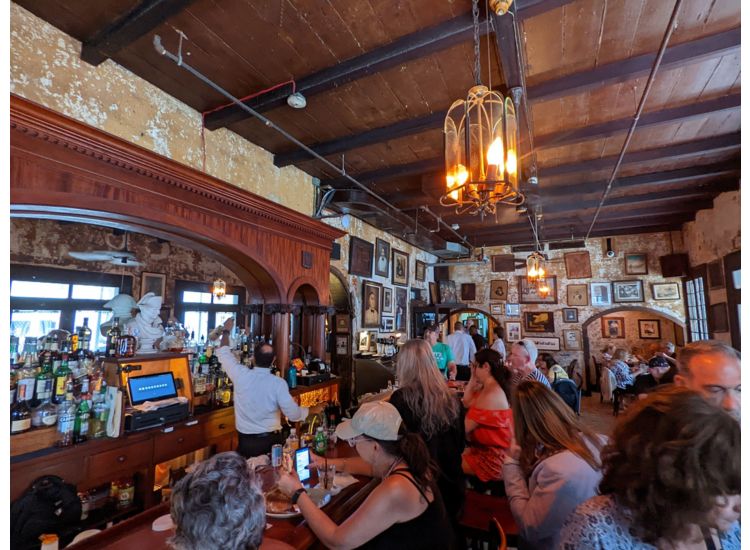 Crowded bar and sitting area of Napoleon House Bar.