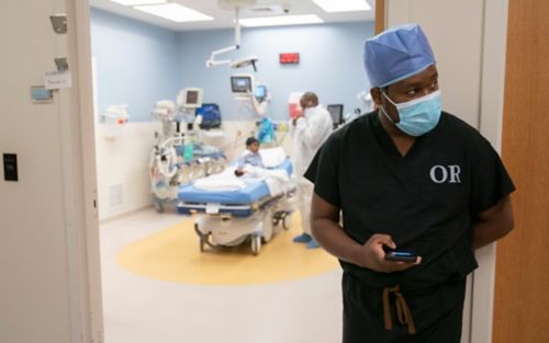 Amon Ngongola, MD, at the door of an exam room