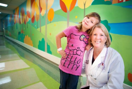 Photo of Kim Nichols, MD, with a patient