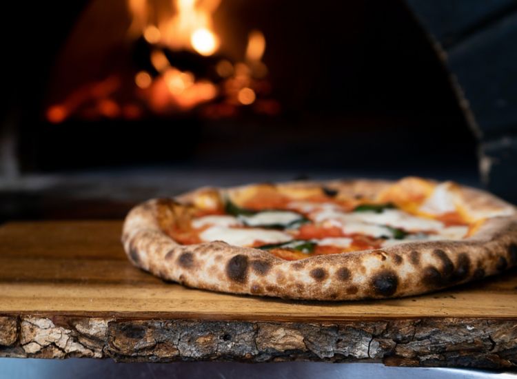 Photo of pizza just out of a wood-fired oven