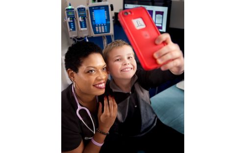 Nurse and young boy take selfie together