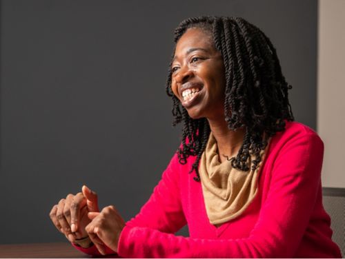 Photo of Esther Obeng sitting at table