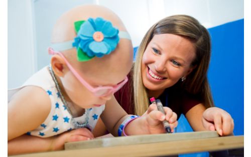 Occupational therapist with child cancer patient
