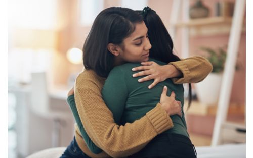 Two female friends hugging