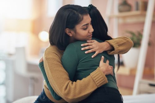 Two female friends hugging