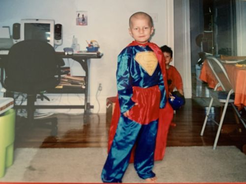 Pablo as a child in a Superman costume