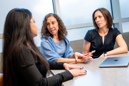 Julie Park at table flanked by two other women.