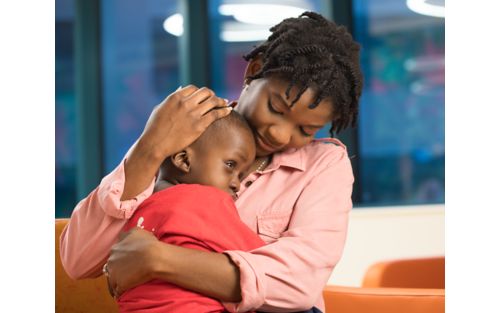 Woman holding child in her arms