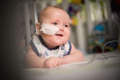 Infant with cancer smiles with NG tube visible